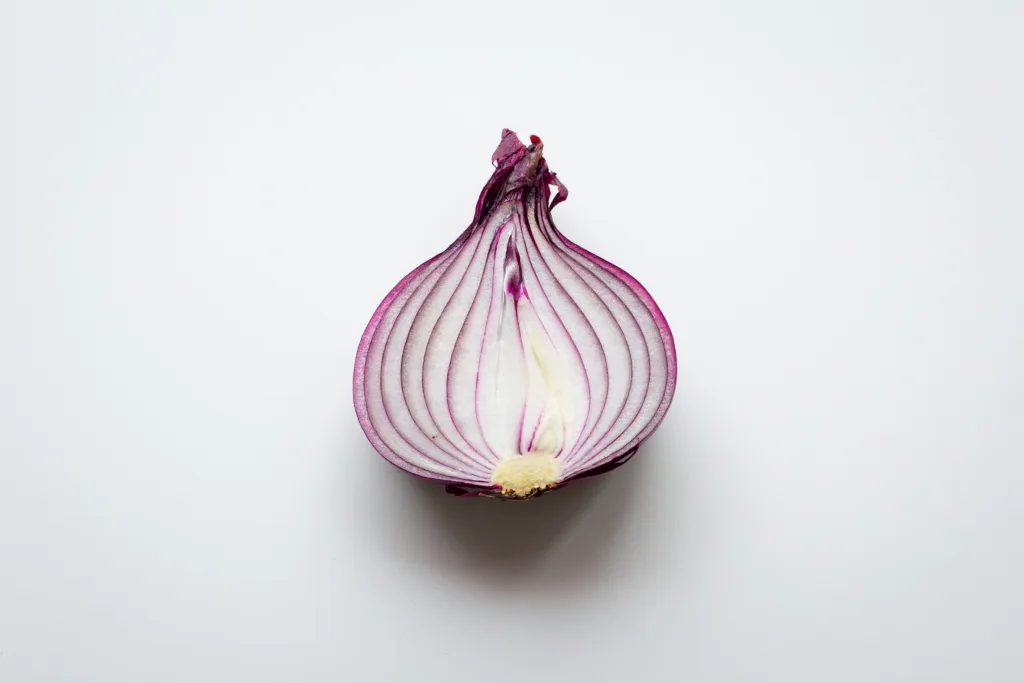 A half cutting onion on the table