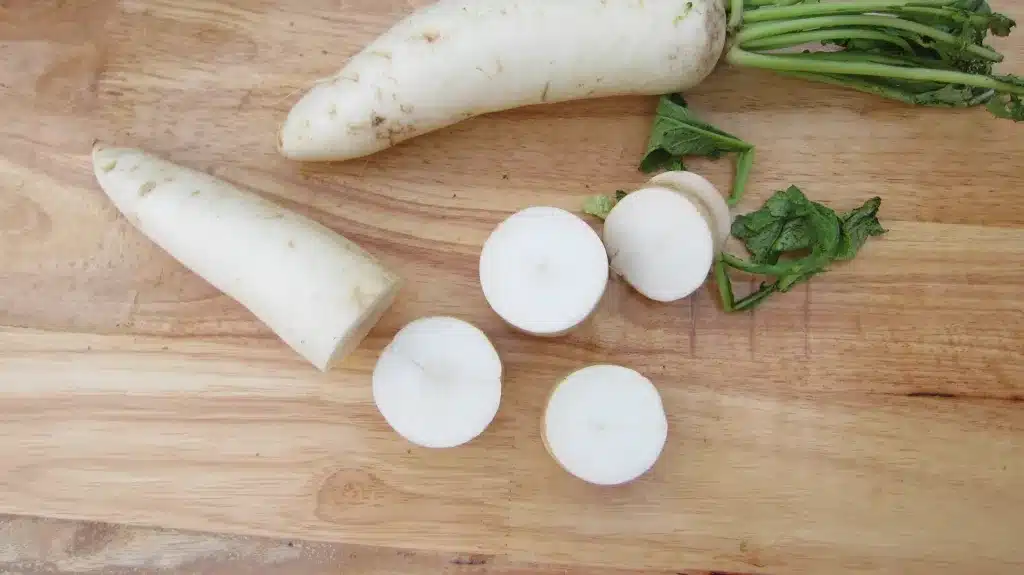 A cutting radishes on the table