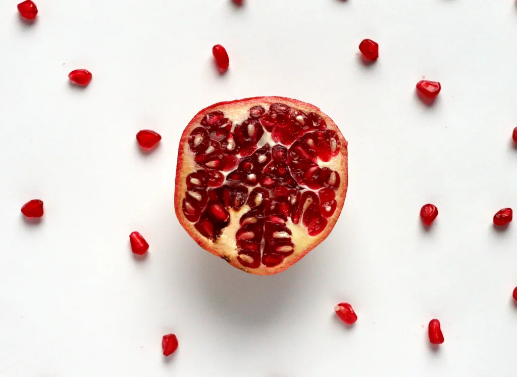 pomegranate on white surface