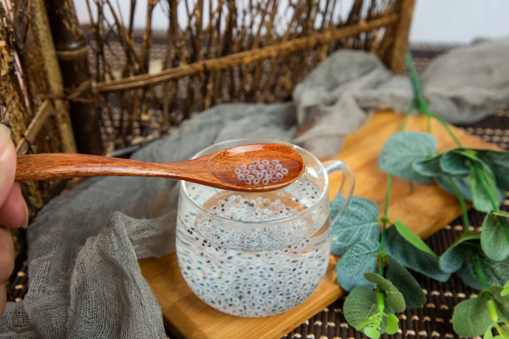 basil seed in the water and wooden spoon